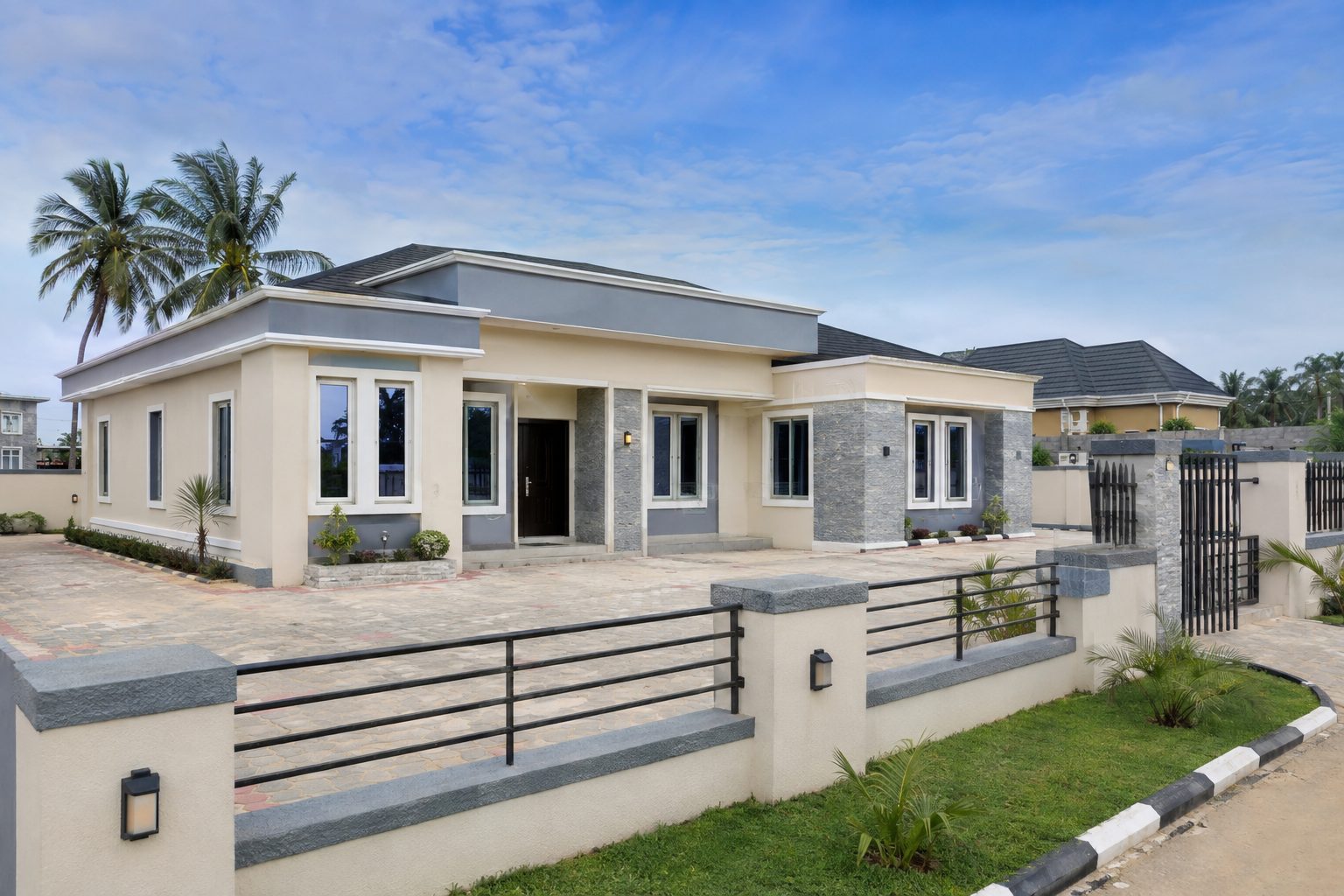 A completed modern home with a walled compound